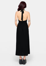 Black halter neck dress with open back worn by a woman on a white background