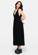 Woman wearing a black midaxi dress on a white background