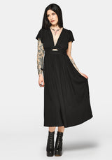Woman wearing a black dress with cut-out design and short sleeves on a white background