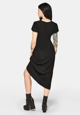 Woman wearing a black dress with cut-out design and short sleeves on a white background