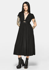 Woman wearing a black dress with cut-out design and short sleeves on a white background