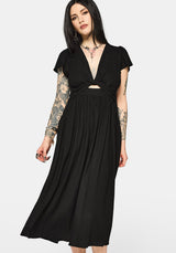 Woman wearing a black dress with cut-out design and short sleeves on a white background
