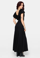 Woman wearing a black dress with open back on a white background