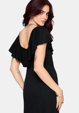 Woman wearing a black dress with open back on a white background