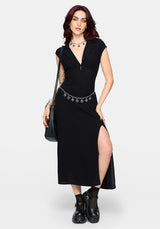 Woman wearing a black dress with a slit on a white background