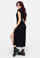Woman wearing a black midaxi dress with a slit on a white background