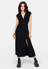Woman wearing a black midaxi dress with a slit on a white background