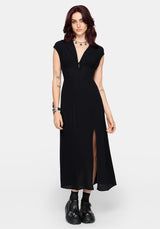 Woman wearing a black dress with a slit on a white background