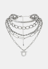 A layered silver-tone chain necklace with multiple link styles and a small horse-head charm, displayed on a light gray background.