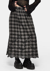 Woman wearing a black and gray checkered skirt with lace details on a white background