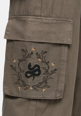 Snake embroidered design on a pocket of brown wide leg cargo pants