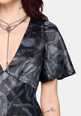 Close up details of black maxi dress with snake print 