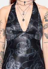 Close up detail of a black satin halterneck mini dress with all over snake print 