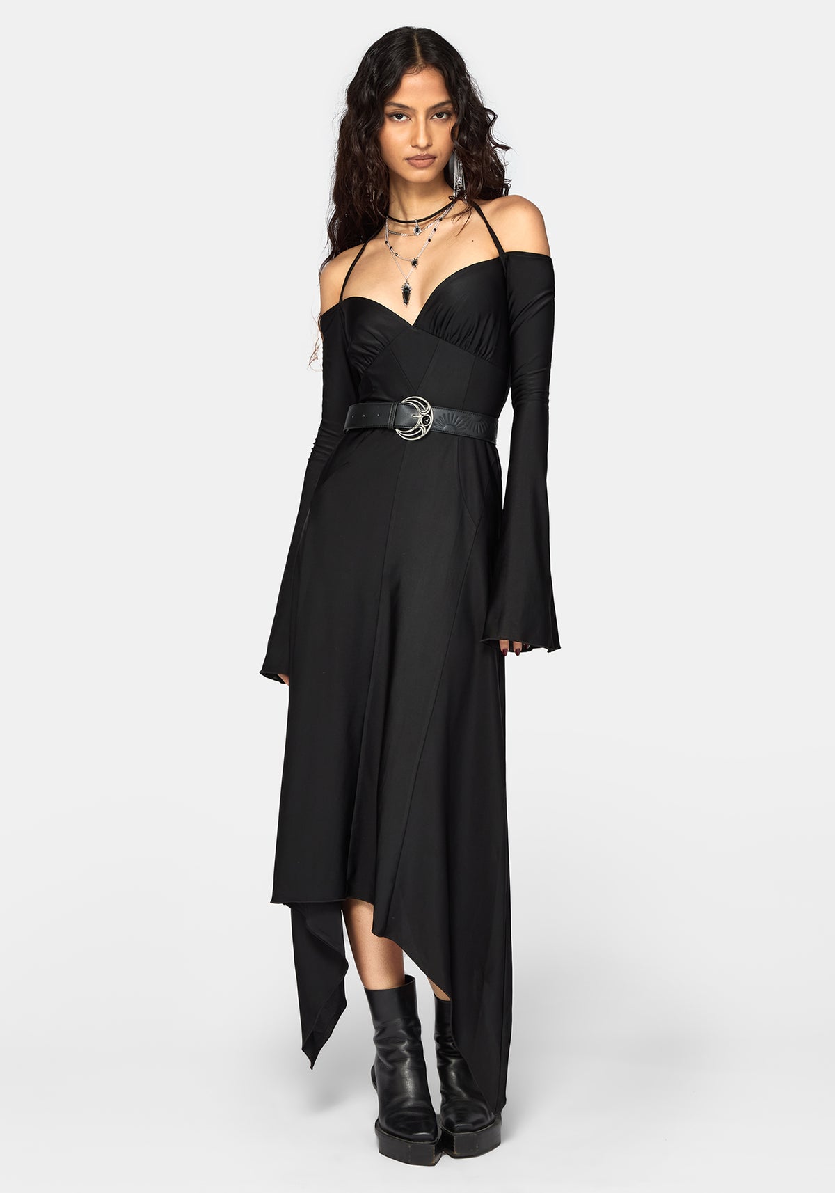 A model wearing a black off-the-shoulder midi dress with long bell sleeves, a sweetheart neckline, and a matching black belt with a silver buckle, styled with black platform ankle boots against a light gray background.