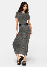 A woman modeling a short-sleeve, crew-neck gray knit maxi dress with a textured, washed finish. The dress is cinched at the waist with a black belt featuring silver buckle details.