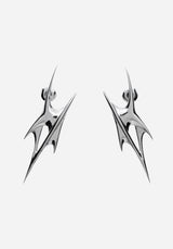 A pair of silver-toned geometric drop earrings with a sharp, angular spike design, shown against a plain light gray background.