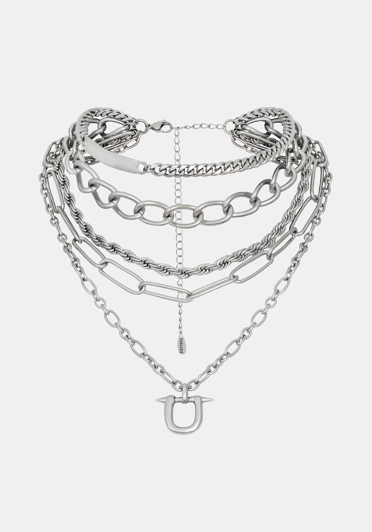 A layered silver-tone chain necklace with multiple link styles and a small horse-head charm, displayed on a light gray background.