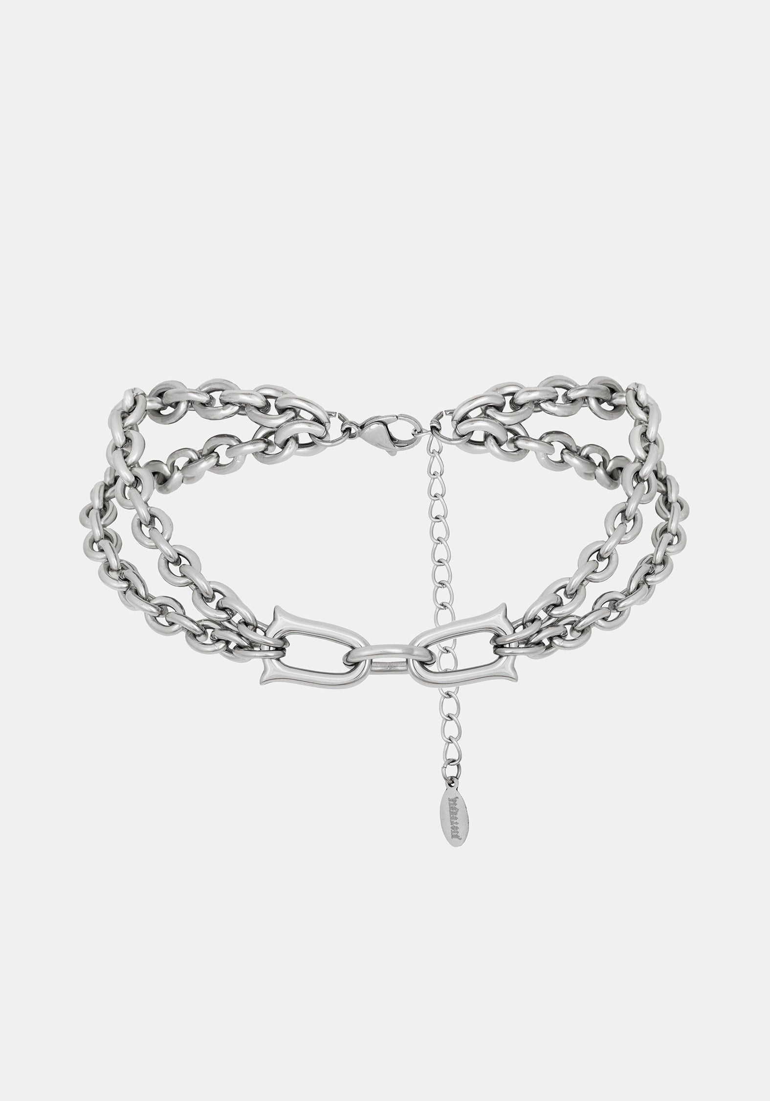 A close-up of a chunky silver double chain choker necklace with extender clasp 