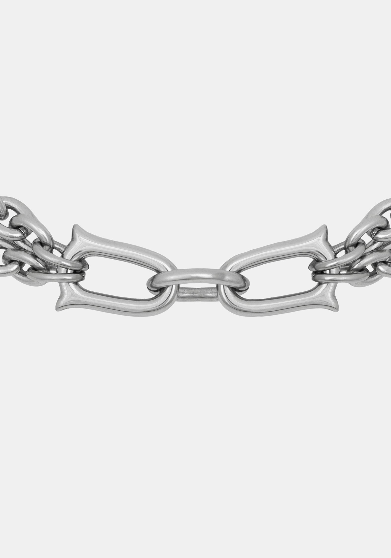 A close-up of a polished silver-toned metal chain with elongated oval links and decorative curved ends, shown against a plain light gray background.