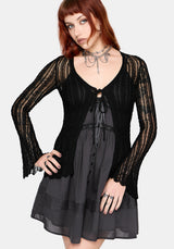 Women's black long sleeve distressed cardigan with v-neckline and self tie function at chest, against a white studio background
