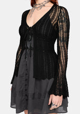 Women's black long sleeve distressed cardigan with v-neckline and self tie function at chest, against a white studio background