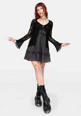 Women's black long sleeve distressed cardigan with v-neckline and self tie function at chest, against a white studio background