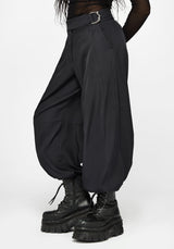 Black baggy balloon trousers with a silver buckle belt, worn by a model with black platform combat boots against a light gray background.